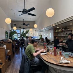 Interior of restaurant. Bar on right and booths on left