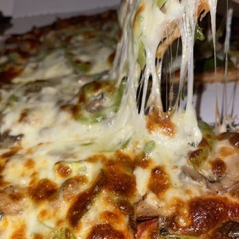 Nonno Carm's pizza & pasta - a slice being taken out of the pizza - Pizza Near Me - Wheaton, Illinois Nonno Carm's pizza & pasta - a slice being taken out of the pizza - Pizza Near Me - Wheaton, Illinois