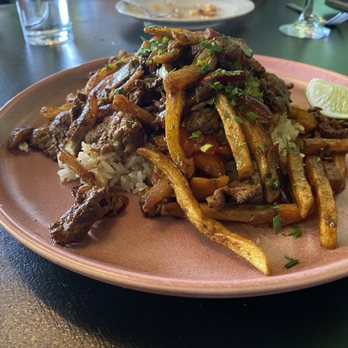 Cafe Americana - Lomos Saltado Steak, cilantro rice, charred peppers & potato strings. - Tapas/Small Plates Near Me - Arlington, Texas