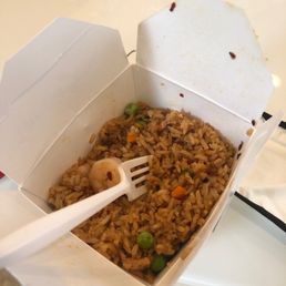 a take out box of rice with a fork a take out box of rice with a fork