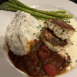 Two tasty crab cakes with asparagus and mashed potatoes. Lunch.