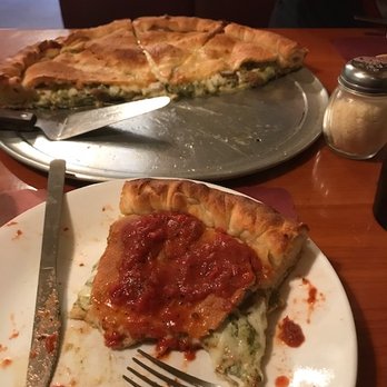 Pizza Di Folco - The stuffed pizza, slice in front cover in the sauce. - Pizza Near Me - Buford, Georgia Pizza Di Folco - The stuffed pizza, slice in front cover in the sauce. - Pizza Near Me - Buford, Georgia