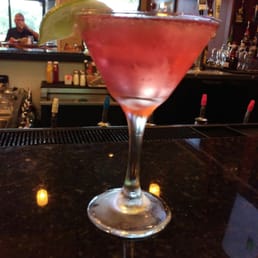a pink cocktail in a martini glass a pink cocktail in a martini glass