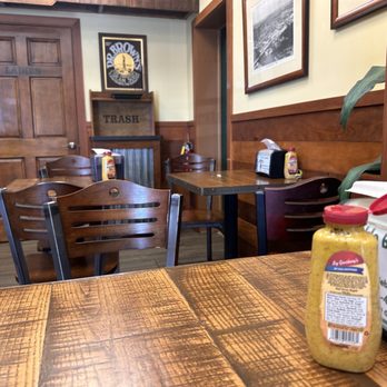 Pickle Barrel Deli - a woman sitting at a table in a restaurant - Delis Near Me - Deerfield Beach, Florida