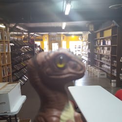 Super-Fly Comics & Games - Bob the Raptor Says "This is a good place to get comic reading paper."