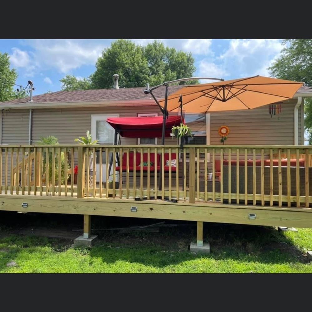 Evolution Contracting - a deck with a red umbrella - General Contractors Near Me - Madison, Illinois Evolution Contracting - a deck with a red umbrella - General Contractors Near Me - Madison, Illinois