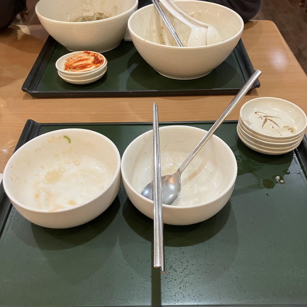 Charm Juk - After. All done! Note the amount of side dishes stacked up. They are very generous with their sides. - Korean Near Me - Carrollton, Texas