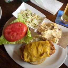 Fish sandwich with coleslaw and potato salad