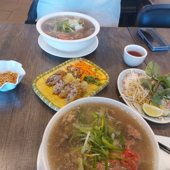 Pho Hoang Gia - a bowl of soup and two plates of food - Vietnamese Near Me - Markham, Ontario