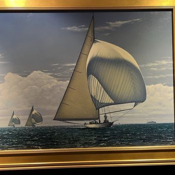 Cape Cod Museum of Art - A framed painting depicts multiple sailboats with large sails on the ocean, with a cloudy sky overhead and a distant ship on the horizon. - Museums Near Me - Dennis, Massachusetts