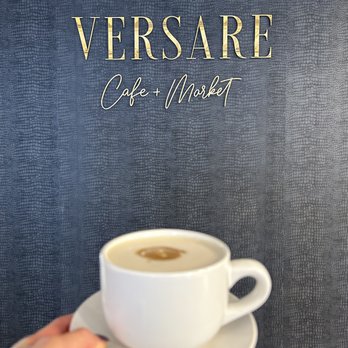 Versare Cafe + Market - a hand holding a cup of coffee - Coffee & Tea Near Me - Chesterland, Ohio Versare Cafe + Market - a hand holding a cup of coffee - Coffee & Tea Near Me - Chesterland, Ohio