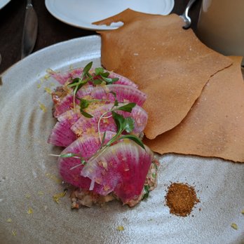Spoon and Stable - Bison Tartare, hidden under pickled radish. Harisa powder on the side for extra flavor (not needed) - New American Near Me - Minneapolis, Minnesota Spoon and Stable - Bison Tartare, hidden under pickled radish. Harisa powder on the side for extra flavor (not needed) - New American Near Me - Minneapolis, Minnesota