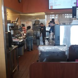 Dunkin' - Unmasked employee hovering over my food.