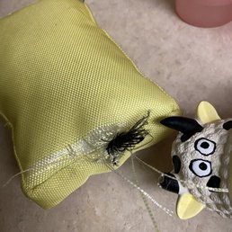 Doggy bit an ear off the cow and tore open the yellow toy.