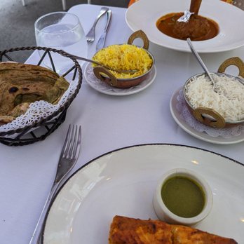 Rasika - Salmon (near plate) and lamb shank (far plate) with rice and naan/paratha in basket - Indian Near Me - Washington, DC, District of Columbia Rasika - Salmon (near plate) and lamb shank (far plate) with rice and naan/paratha in basket - Indian Near Me - Washington, DC, District of Columbia
