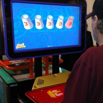 Chuck E. Cheese - a man playing a video game - Pizza Near Me - Canton, Michigan