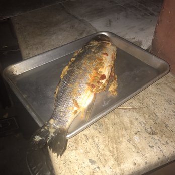 Thomas Hill Organics - Branzino stuffed with olive tapenade going into outdoor hearth - New American Near Me - Paso Robles, California Thomas Hill Organics - Branzino stuffed with olive tapenade going into outdoor hearth - New American Near Me - Paso Robles, California