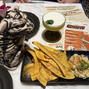 Otto’s High Dive - Seasonal fall drinks: Hellhound and the Poison ivy with lump crab meat and plantain chips. - Cocktail Bars Near Me - Orlando, Florida Otto’s High Dive - Seasonal fall drinks: Hellhound and the Poison ivy with lump crab meat and plantain chips. - Cocktail Bars Near Me - Orlando, Florida