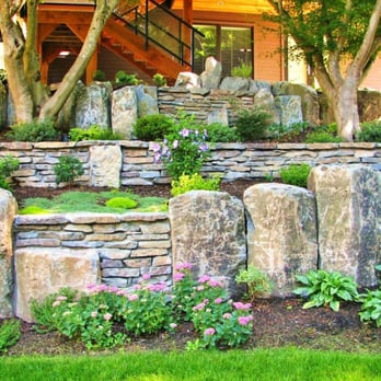Coastal Design Landscaping - a stone retaining wall in front of a house - Landscaping Near Me - Coquitlam, British Columbia Coastal Design Landscaping - a stone retaining wall in front of a house - Landscaping Near Me - Coquitlam, British Columbia