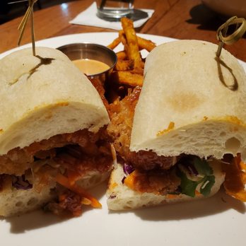 Kona Grill - Baltimore - Spicy garlic chicken sandwich with sweet potato fries - New American Near Me - Baltimore, Maryland Kona Grill - Baltimore - Spicy garlic chicken sandwich with sweet potato fries - New American Near Me - Baltimore, Maryland