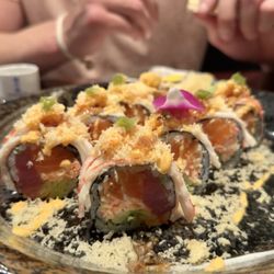 Custom roll with tuna, salmon, crab, and avocado inside + crabmeat and tempura flakes on top with fresh wasabi.