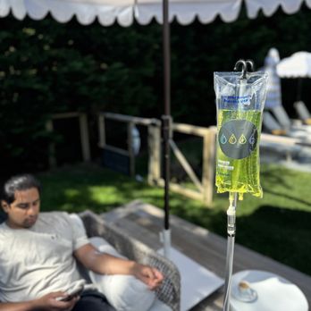 IV Elements - An IV Elements client relaxing outdoors on a shaded patio during an in-home IV therapy session. - IV Hydration Near Me - Asbury Park, New Jersey IV Elements - An IV Elements client relaxing outdoors on a shaded patio during an in-home IV therapy session. - IV Hydration Near Me - Asbury Park, New Jersey