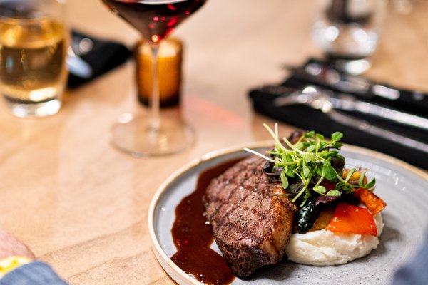 Photo of Barnwood - Niagara Falls, ON, CA. a plate of food and a glass of wine