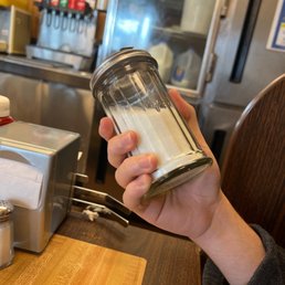 a person holding a jar of waffles a person holding a jar of waffles