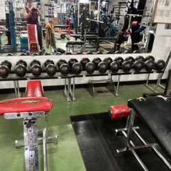 Loprinzi's Gym - Great Decline Bench setup for both decline benching & Weighted Situps. That and classic circus dumbbell rack.