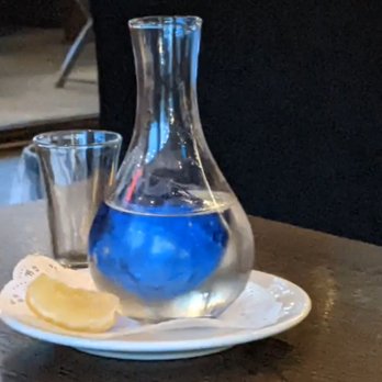 Thai Dishes - Chilled sake. The blue thing is a cut out that has an ice cube in it. - Thai Near Me - Redondo Beach, California
