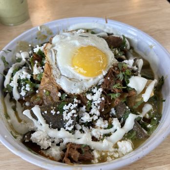 CasaEma - Chilaquiles on black beans, with green tomatillo salsa, crema, queso fresco, brisket on top AND a fried egg! FABULOUS! - Mexican Near Me - Houston, Texas CasaEma - Chilaquiles on black beans, with green tomatillo salsa, crema, queso fresco, brisket on top AND a fried egg! FABULOUS! - Mexican Near Me - Houston, Texas