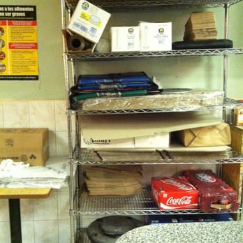 Circle Pizza - a table and shelves of pizza - Pizza Near Me - Bronx, New York
