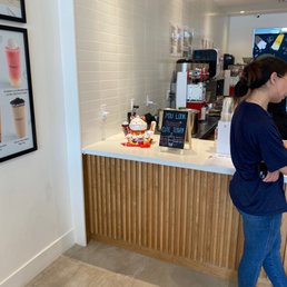a woman standing in a coffee shop