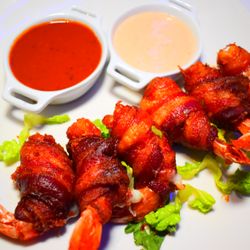 Eclipse Azul Kitchen & Lounge - Camarones evueltos (Bacon Wrapped shrimps) accompanied with spicy tamarind sauce and chipotle mayo.