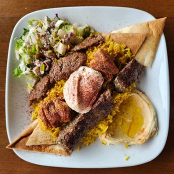 Tiba Grill - Mixed Kabob plate, with rice as a base, hummus and Greek salad. There were several other options. - Mediterranean Near Me - Longview, Texas
