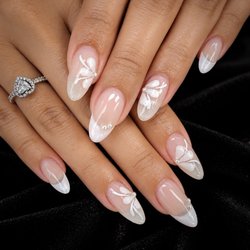 Pure Nails Spa - Soft, timeless, and made for the details. Delicate florals, pearly French tips, and a clean finish that never goes out of style.