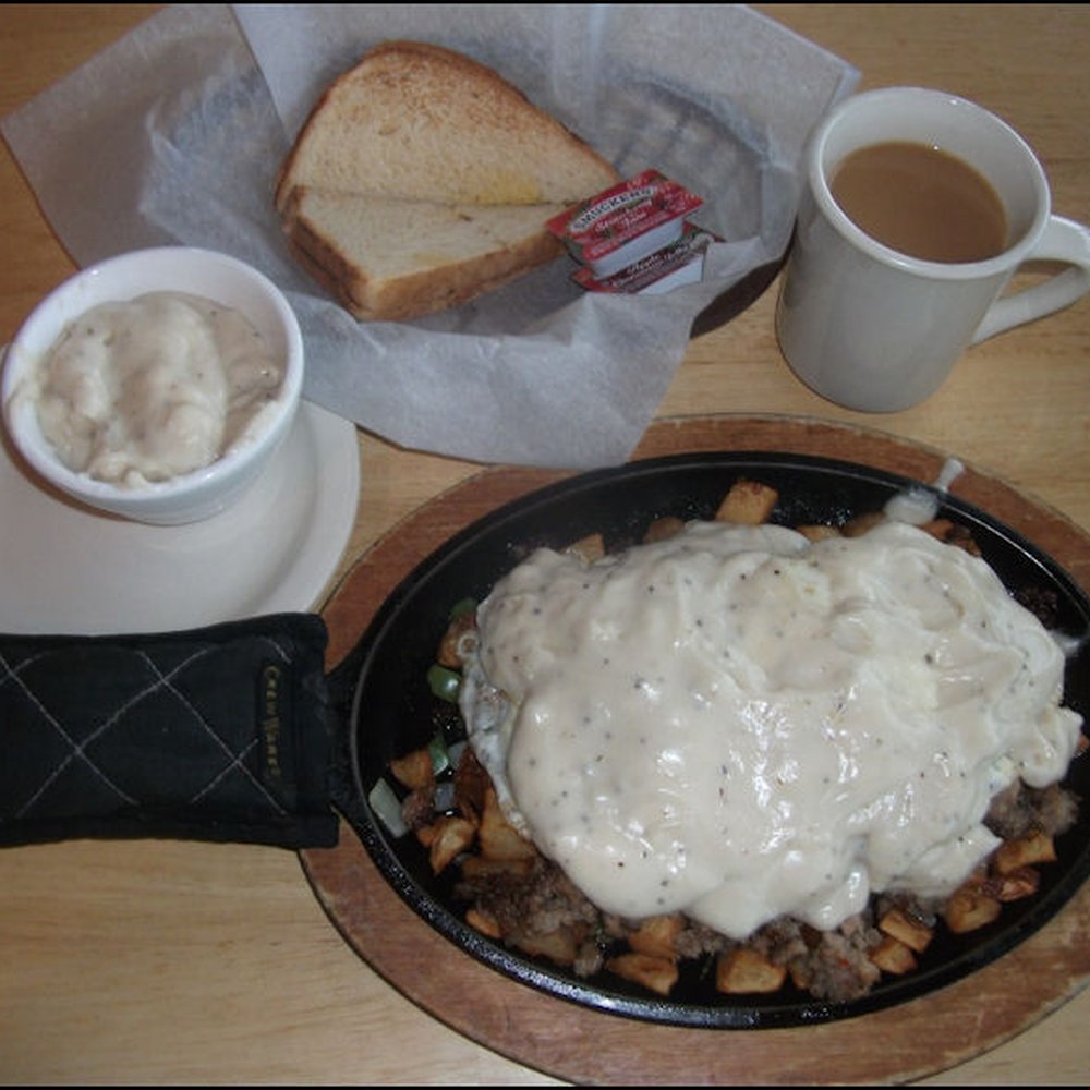 The Roadkill Cafe - My friendly server, Kendra, brings out my "Guess that Mess" breakfast, along with my order of toast. More on the breakfast in a later photo - American Near Me - Seligman, Arizona The Roadkill Cafe - My friendly server, Kendra, brings out my "Guess that Mess" breakfast, along with my order of toast. More on the breakfast in a later photo - American Near Me - Seligman, Arizona