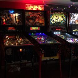Cabin Fever - Row of pinball machines: Twilight Zone, Attack from Mars, Metallica, Star Wars.