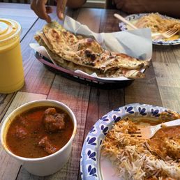 Mango Lassi, Garlic Naan, Chicken Tikka, Goat curry, and Rice Mango Lassi, Garlic Naan, Chicken Tikka, Goat curry, and Rice