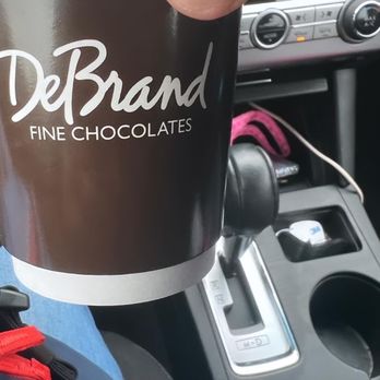 DeBrand Fine Chocolates - a hand holding a coffee cup - Candy Stores Near Me - Fort Wayne, Indiana DeBrand Fine Chocolates - a hand holding a coffee cup - Candy Stores Near Me - Fort Wayne, Indiana