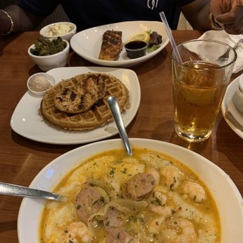 Dame's Chicken and Waffles - Shrimp & grits w/ chicken sausage, vegetarian waffle w/grilled chicken and salmon, greens & potato salad. - New American Near Me - Cary, North Carolina Dame's Chicken and Waffles - Shrimp & grits w/ chicken sausage, vegetarian waffle w/grilled chicken and salmon, greens & potato salad. - New American Near Me - Cary, North Carolina