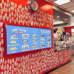 Coney Island Dogs & Burgers - Restaurant interior with massive menu board