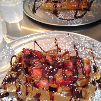 The Waffle Factory - Double Dutch (foreground) with Strawberries in place of Bananas, and the Turtle Waffle in the background. - Breakfast & Brunch Near Me - Webster, New York The Waffle Factory - Double Dutch (foreground) with Strawberries in place of Bananas, and the Turtle Waffle in the background. - Breakfast & Brunch Near Me - Webster, New York