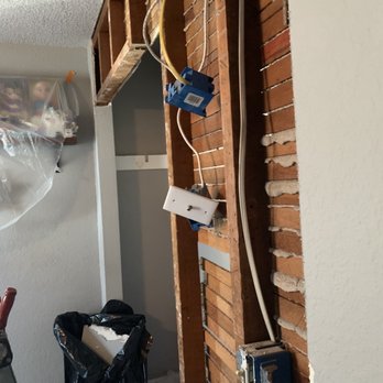 Affordable HandyMan - a brick wall with electrical wires - General Contractors Near Me