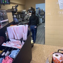  a woman standing in a kitchen