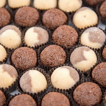 Brigadeiro GO - a close up of a plate of chocolates - Desserts Near Me Brigadeiro GO - a close up of a plate of chocolates - Desserts Near Me