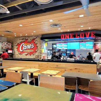 Raising Cane’s - The order counter is under the ONE LOVE sign. The drinks and napkins are to the far left. - Fast Food Near Me - Waldorf, Maryland Raising Cane’s - The order counter is under the ONE LOVE sign. The drinks and napkins are to the far left. - Fast Food Near Me - Waldorf, Maryland