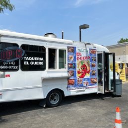 a man standing in front of a food truck a man standing in front of a food truck