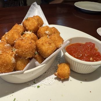Pappadeaux Seafood Kitchen - Fried Mozzarella 10/10 - A serving of fried mozzarella sticks with a side of marinara sauce on a white plate at a restaurant. - Seafood Near Me - Albuquerque, New Mexico