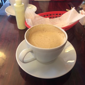 Pastelitos Cafe - Best cappuccino I've maybe ever had. The empty basket held two little meaty pastries and that green sauce: I would drink with a straw. - Breakfast & Brunch Near Me - Houston, Texas